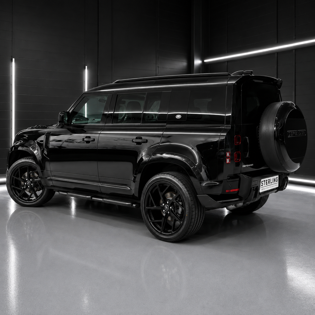 A glossy black SUV shown from a rear three-quarter angle in a dark studio setting with linear LED lighting and a reflective floor.