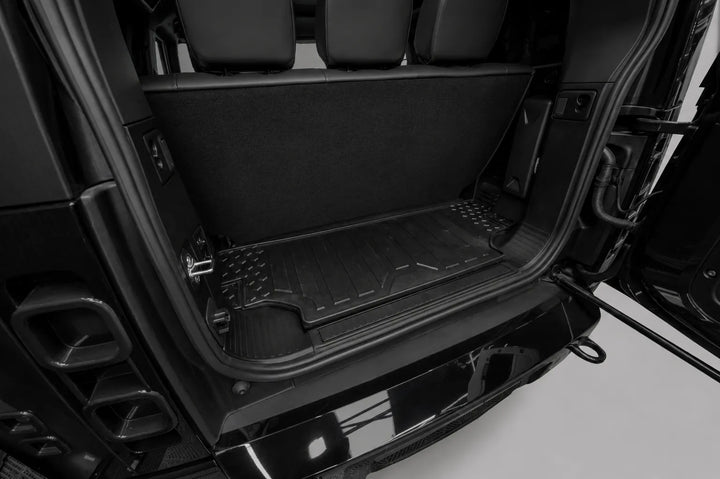 Rear Shot of Land ROver Defender L663 after conversion with seats back with included rear boot mat