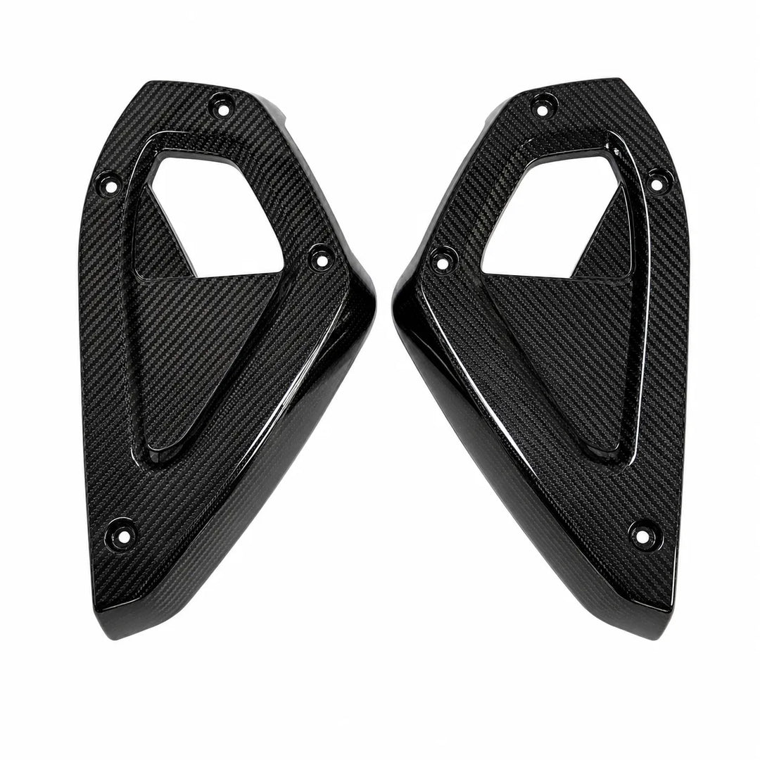 A pair of glossy black carbon fiber dashboard side panels with a textured weave pattern, shown on a plain white background.
