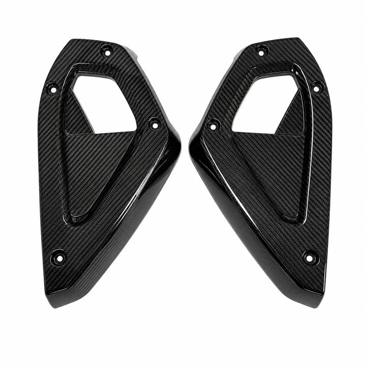 A pair of glossy black carbon fiber dashboard side panels with a textured weave pattern, shown on a plain white background.