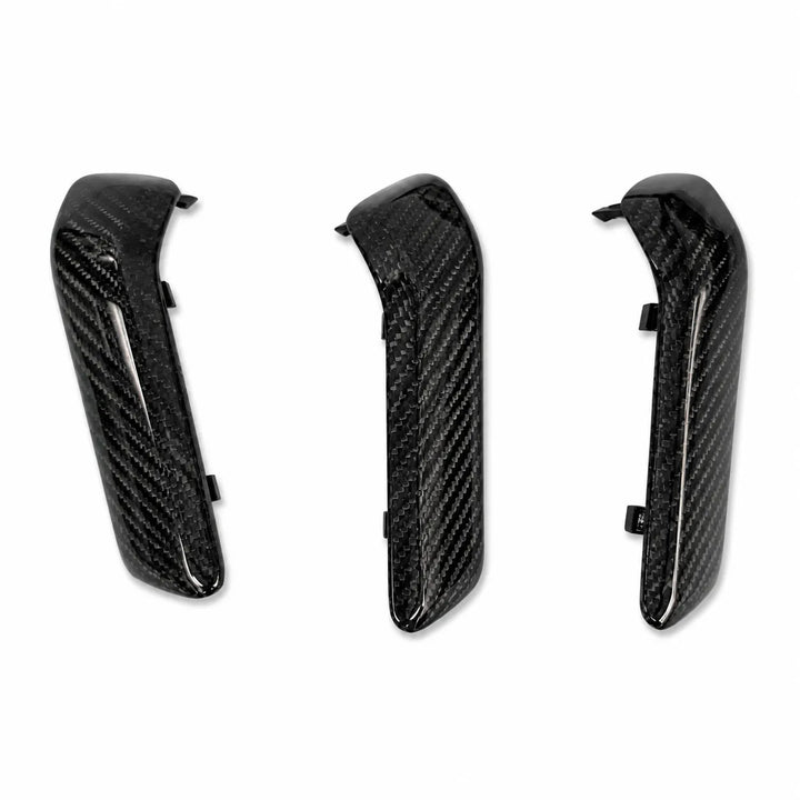 Three black carbon fiber textured carbon interior trim trim pieces shown on a plain white background.