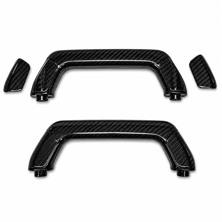 Two black carbon fiber textured car door handle covers with matching small trim pieces, displayed on a clean white background.