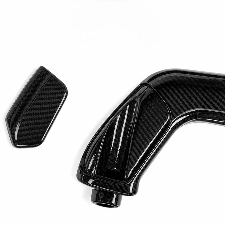 Two glossy black carbon fiber textured carbon covers, one rectangular and one curved, shown on a plain white background.