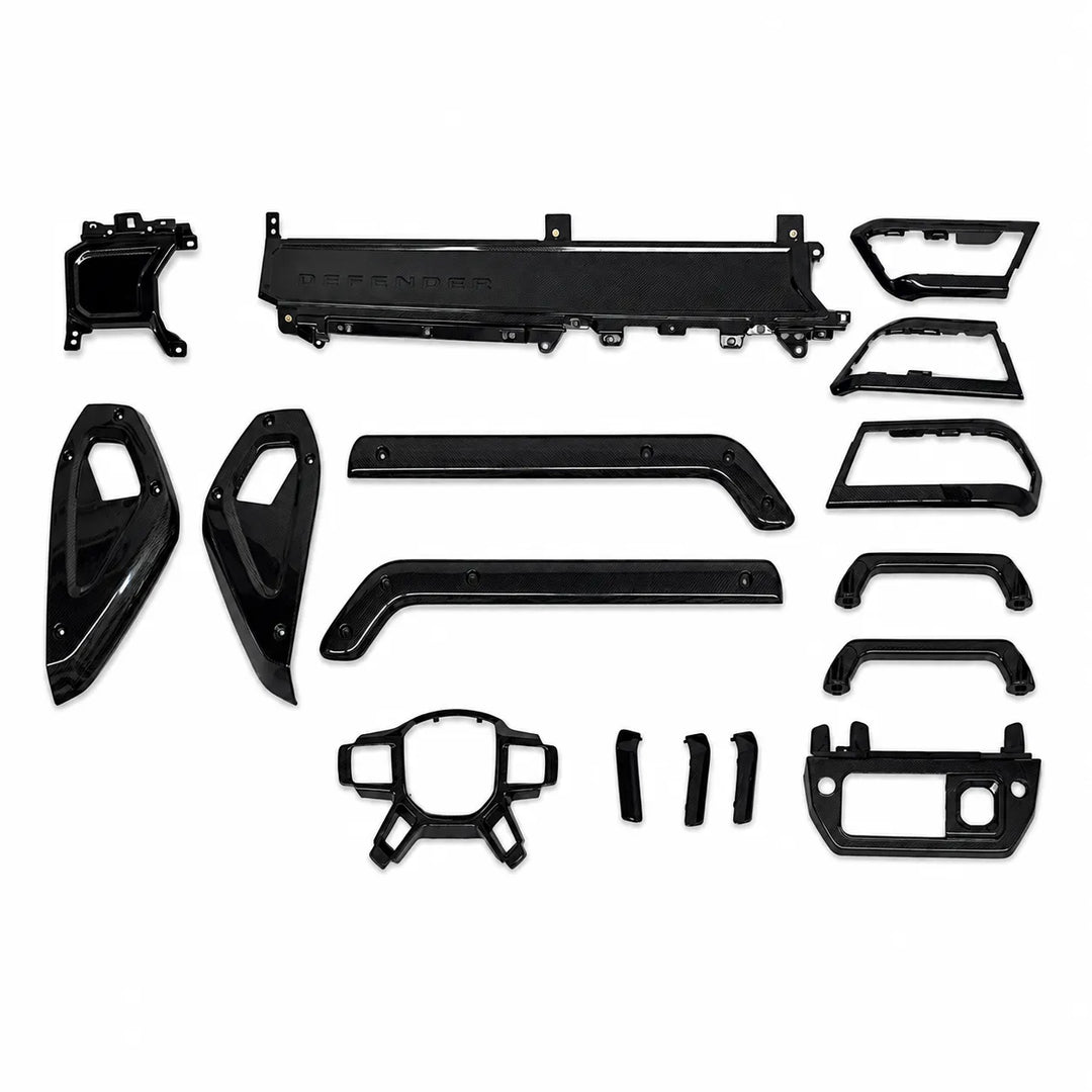 A set of glossy black Carbon trim and body panels for a Defender vehicle, laid out neatly on a solid white background.