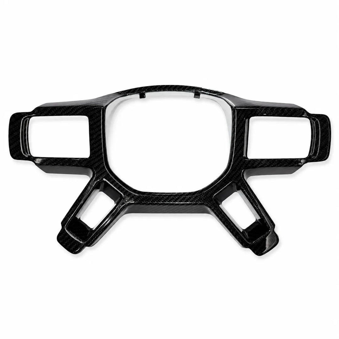 A glossy black carbon fiber trim piece with a carbon weave pattern, designed for automotive dashboard or steering wheel integration, shown on a plain white background.