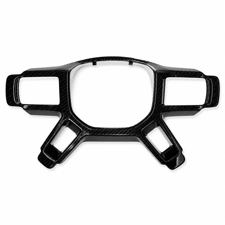 A glossy black carbon fiber trim piece with a carbon weave pattern, designed for automotive dashboard or steering wheel integration, shown on a plain white background.