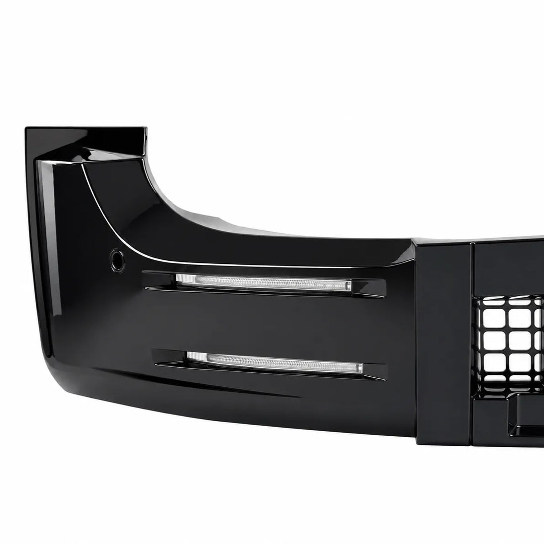 A glossy black automotive bumper lip or front bumper section with integrated horizontal light bars and a grille opening, shown on a plain white background.