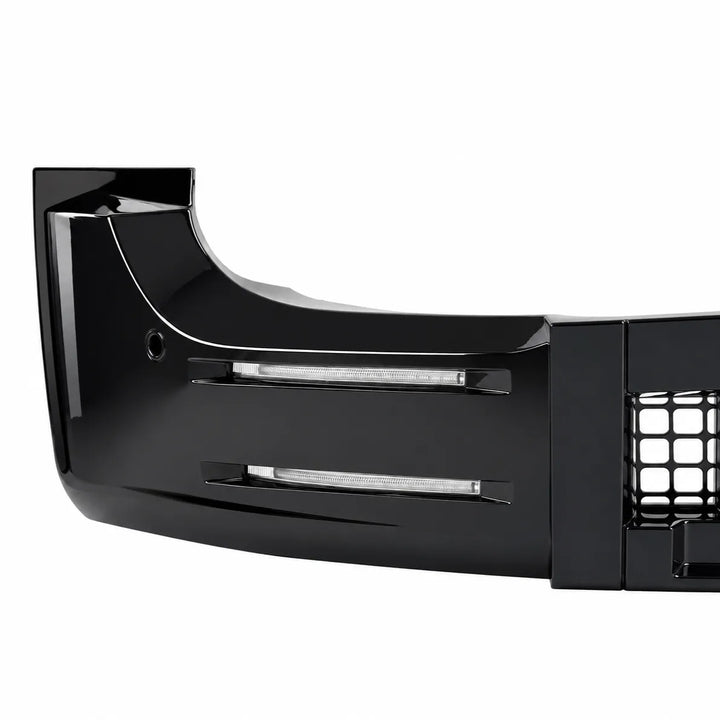 A glossy black automotive bumper lip or front bumper section with integrated horizontal light bars and a grille opening, shown on a plain white background.