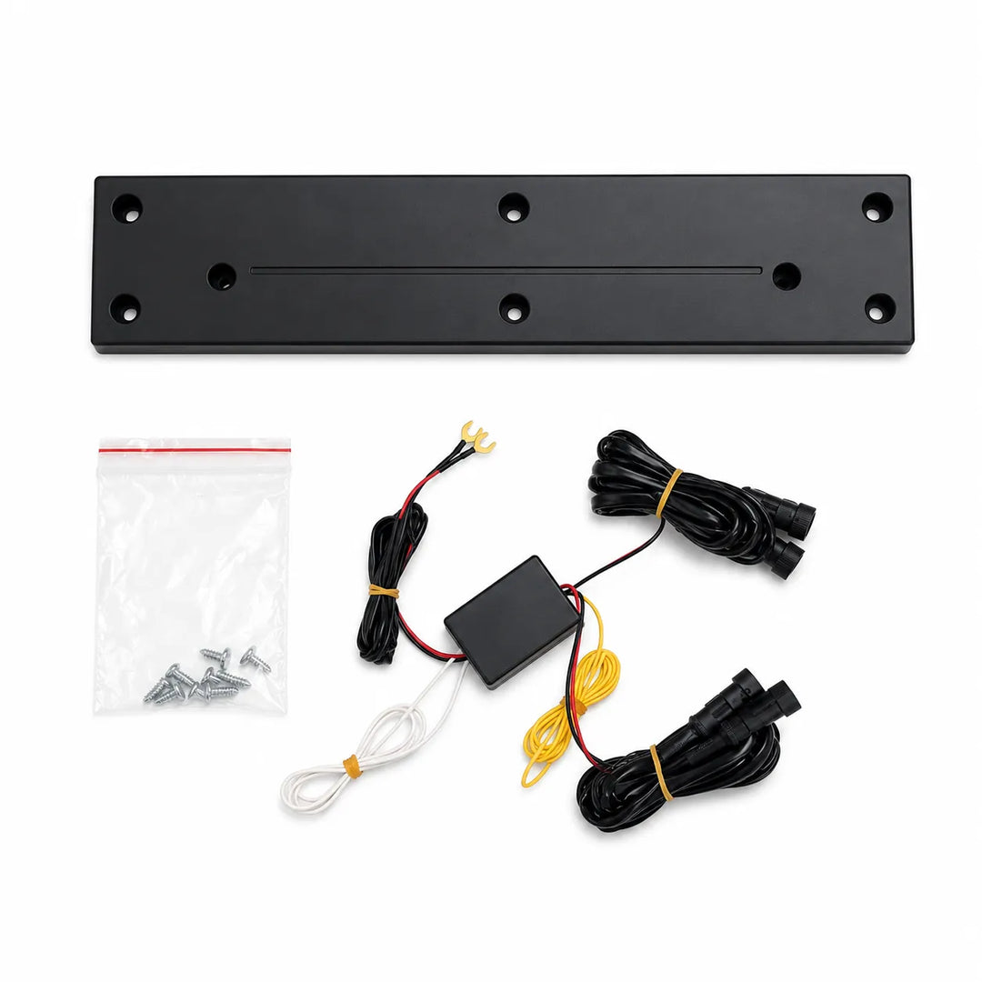 Black metal mounting plate kit with wiring harnesses, a control box, screws, and a zip tie on a white background.