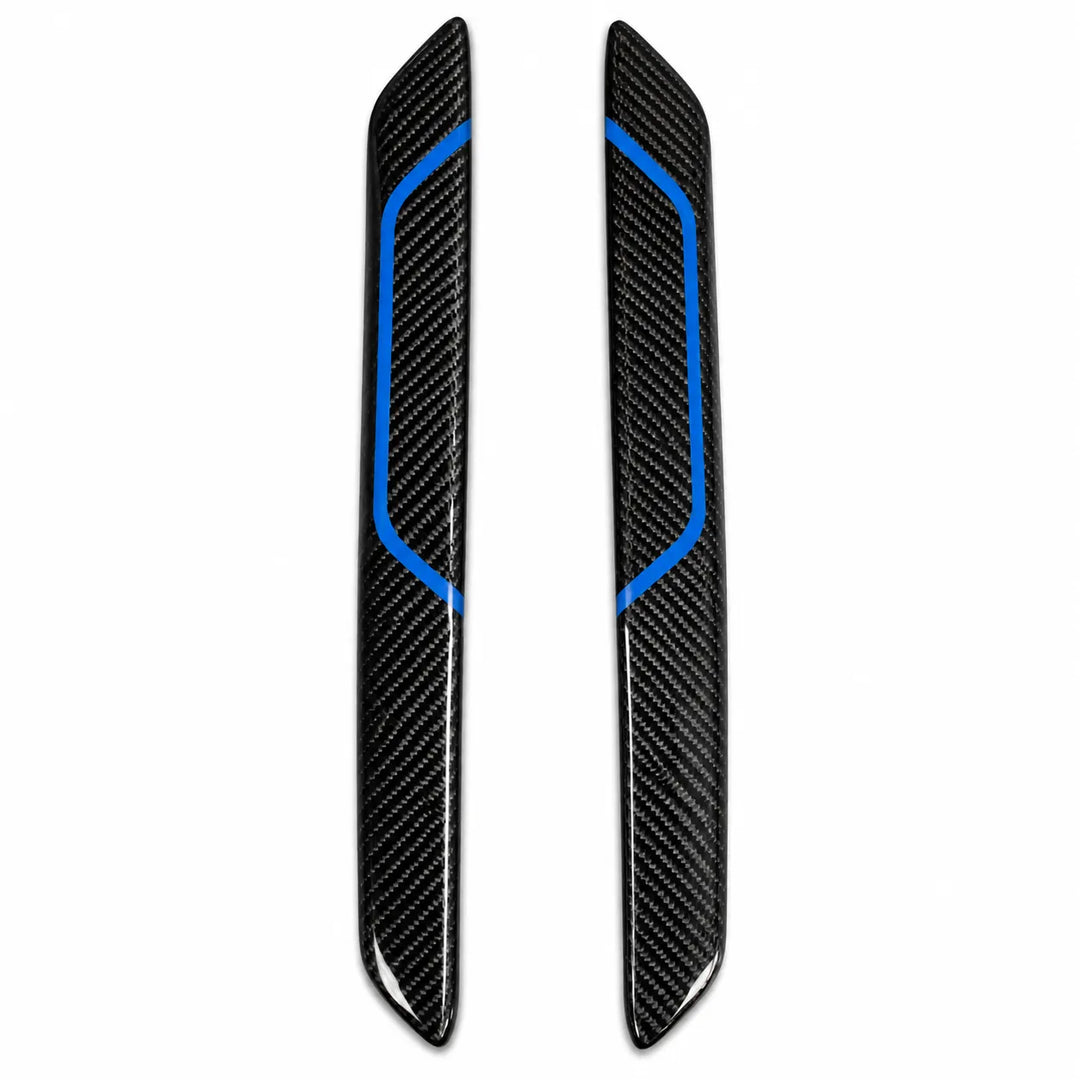 A pair of black carbon fiber Interior trim pieces with bright blue accent lines, displayed vertically on a plain white background.