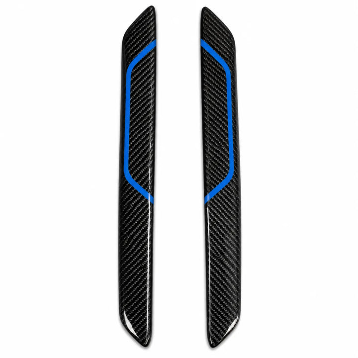 A pair of black carbon fiber Interior trim pieces with bright blue accent lines, displayed vertically on a plain white background.