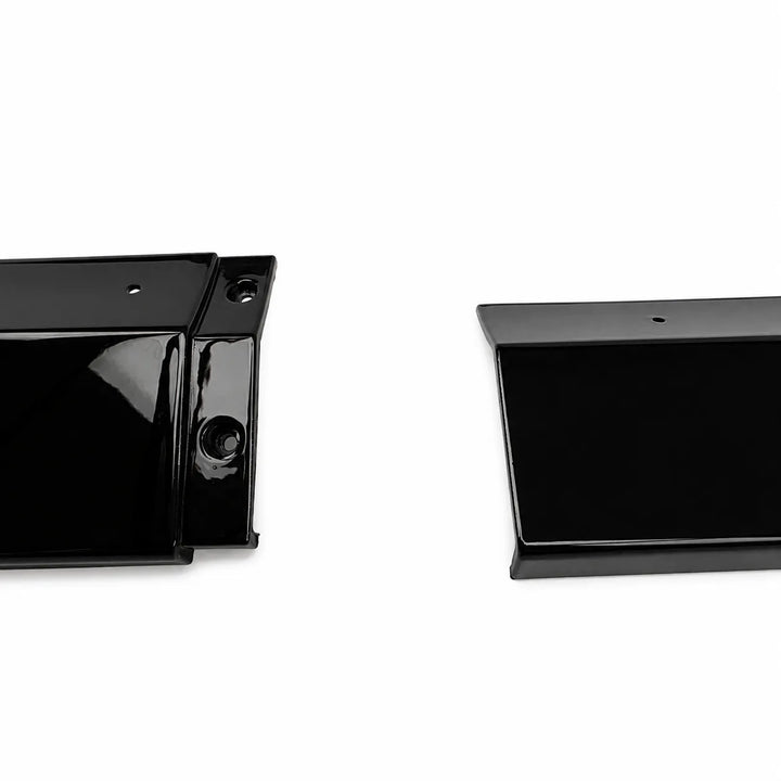 Two glossy black plastic automotive trim pieces, likely bumper lip guards or side marker covers, shown on a plain white background.