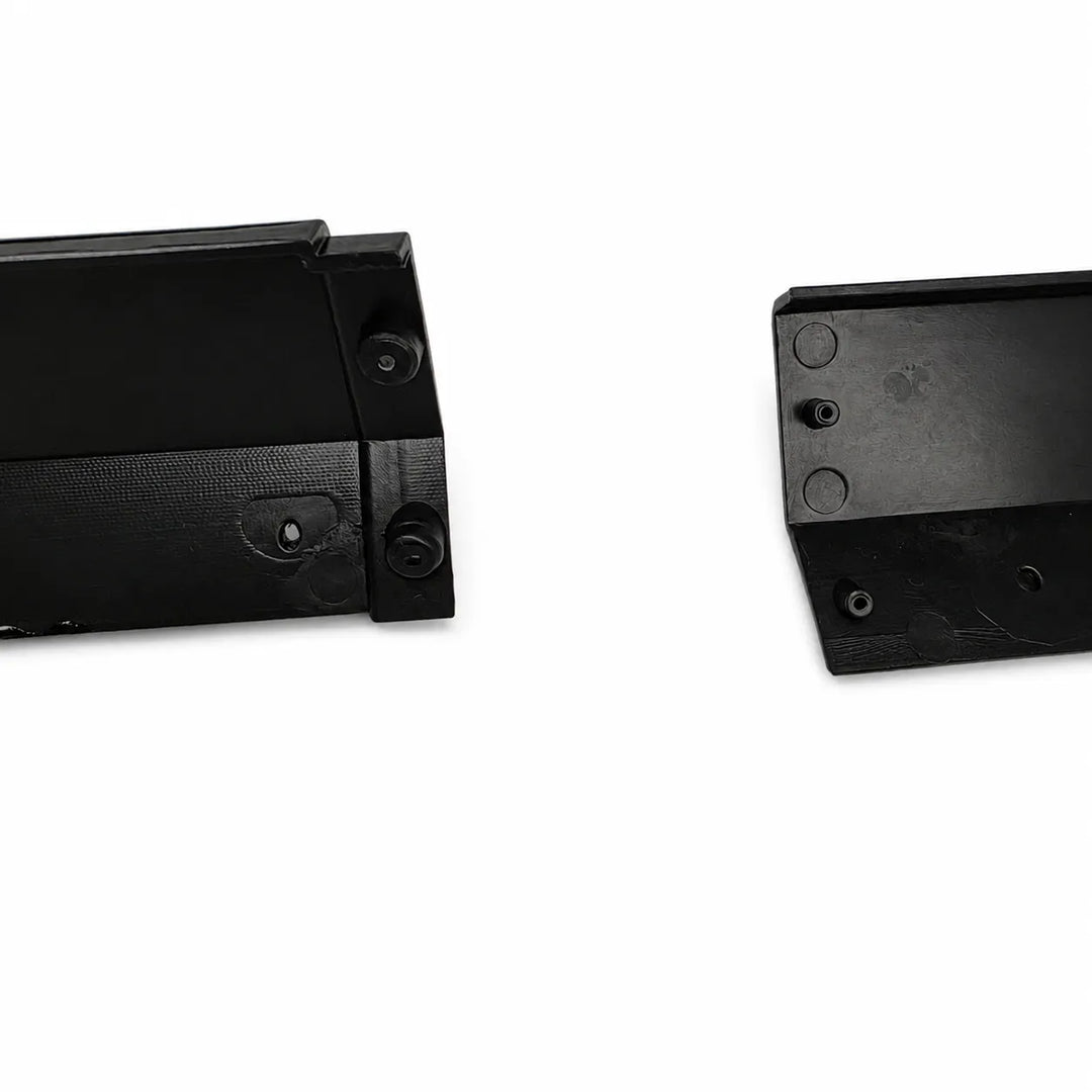 Two black plastic mounting brackets or hardware pieces shown on a plain white background, with one piece displaying the side and the other showing the top surface with screw holes.
