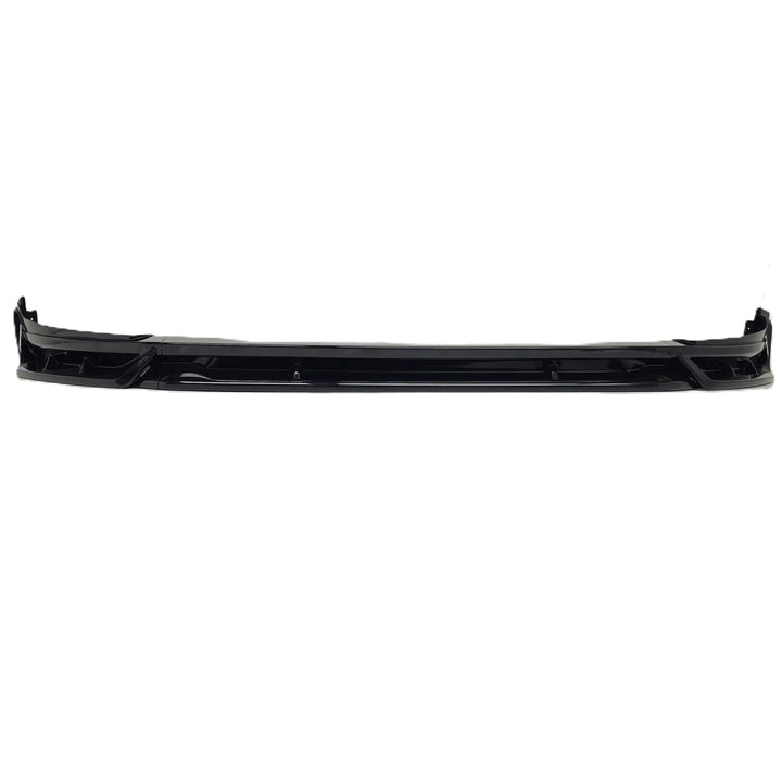 A black plastic car front bumper lip or splitter trim piece, low valance shot, shown horizontally against a plain white background.