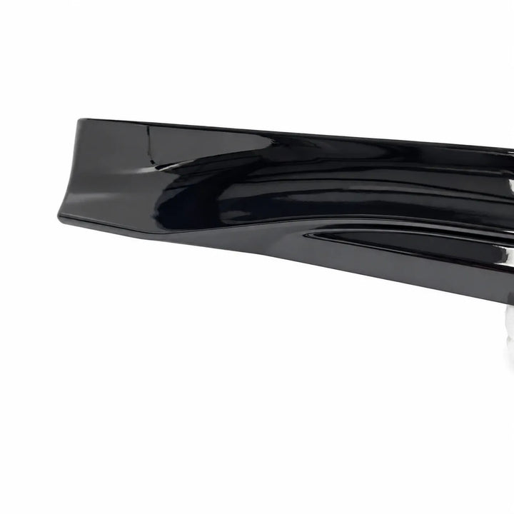 A glossy black automotive skirt lip or splitter trim piece shown on a plain white background.