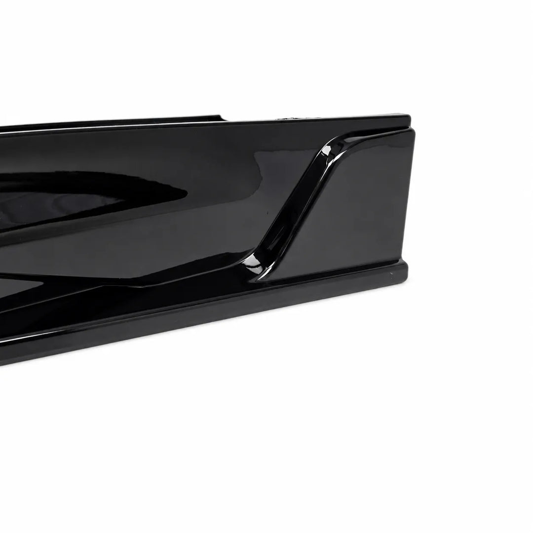 A close-up of a glossy black automotive spoiler or trim piece on a plain white background.