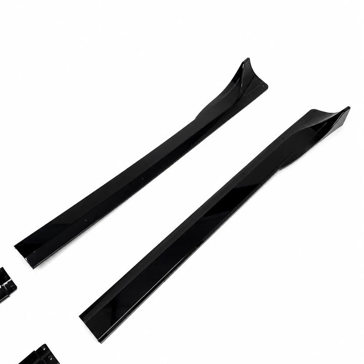 A Tesla Model Y pair of black side skirts, long black side skirt partial pieces displayed below on a white background. 