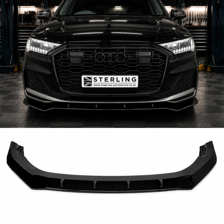 A black glossy automotive front lip spoiler bumper splitter shown below, with a black Audi q7 vehicle above on the sterling workshop floor. The license plate area on the car reads STERLING. product displayed on the bottom 