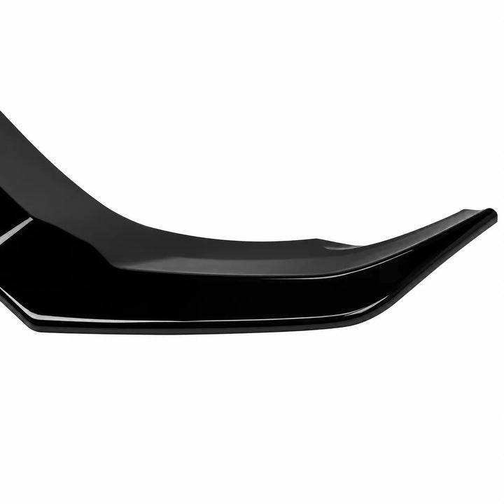 A close-up of a glossy black automotive body trim piece or spoiler edge against a plain white background.