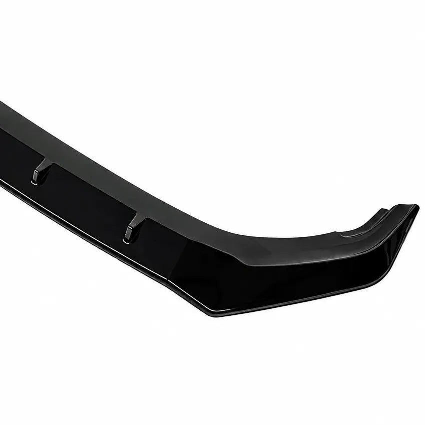 A glossy black automotive body trim piece, front splitter lip spoiler, shown against a plain white background.