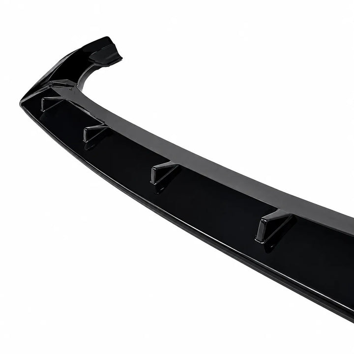 A glossy black car Q7 front bumper lip spoiler with integrated mounting points, shown at an angle on a solid white background.
