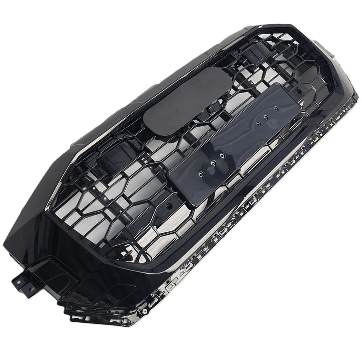 A black plastic car grille insert with a honeycomb pattern, shown on a solid white background.