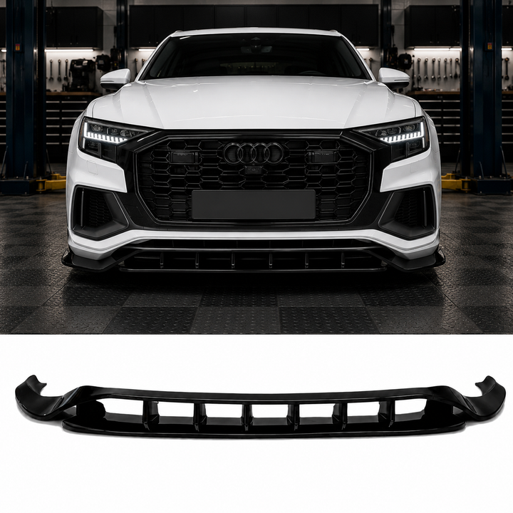A glossy black front splitter lip valance spoiler shown below, with a white Audi Q7 with RS style grille above in a garage setting demonstrating its fitment.