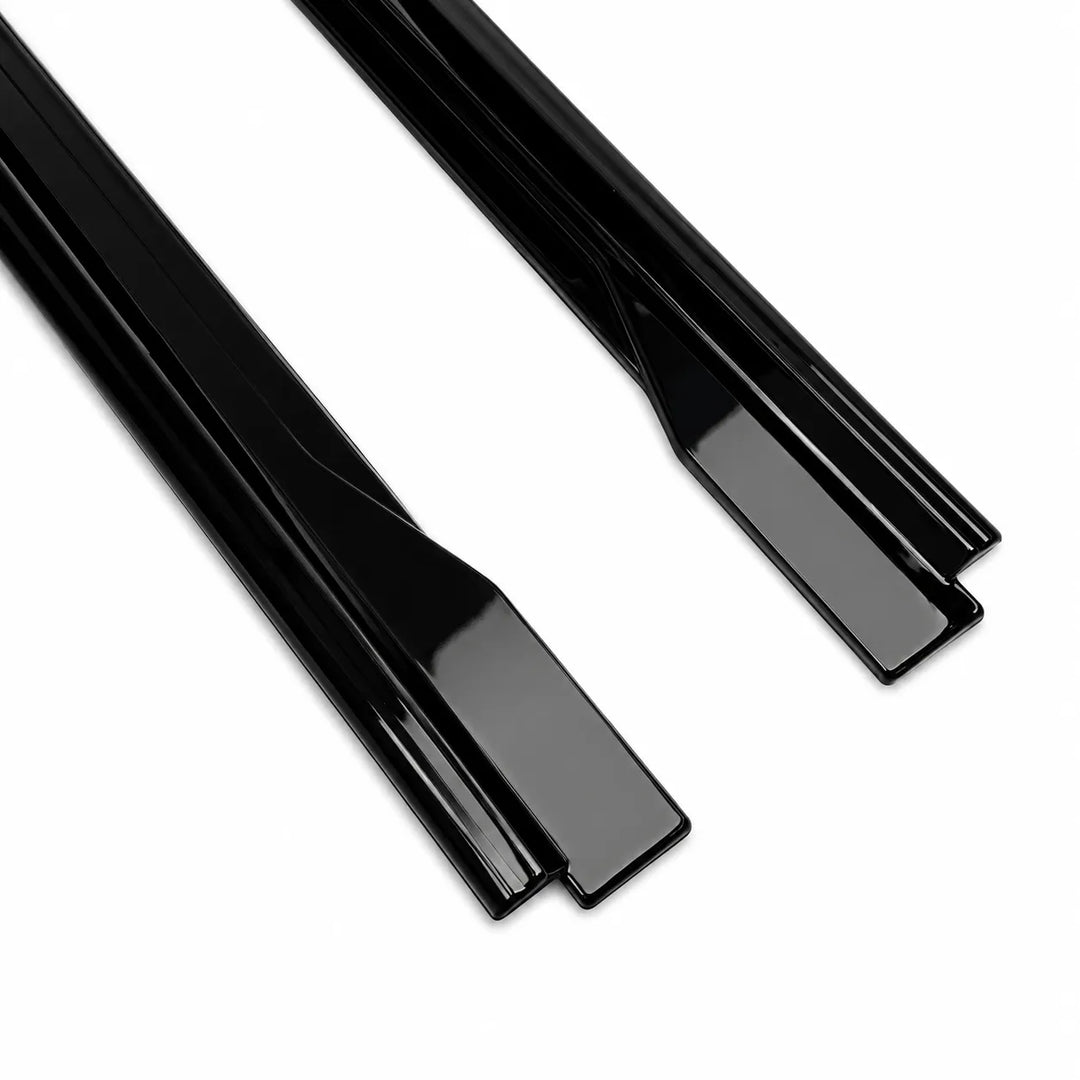 Two, single piece close up end shot of glossy black ABS plastic side track shown diagonally on a plain white background.