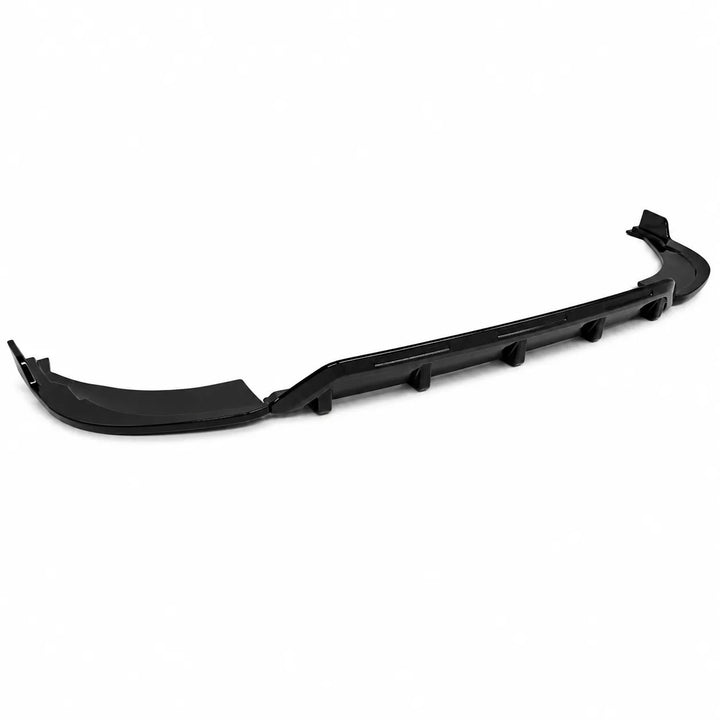 A black plastic automotive front splitter lip spoiler, shown from a three-quarters perspective against a solid white background.