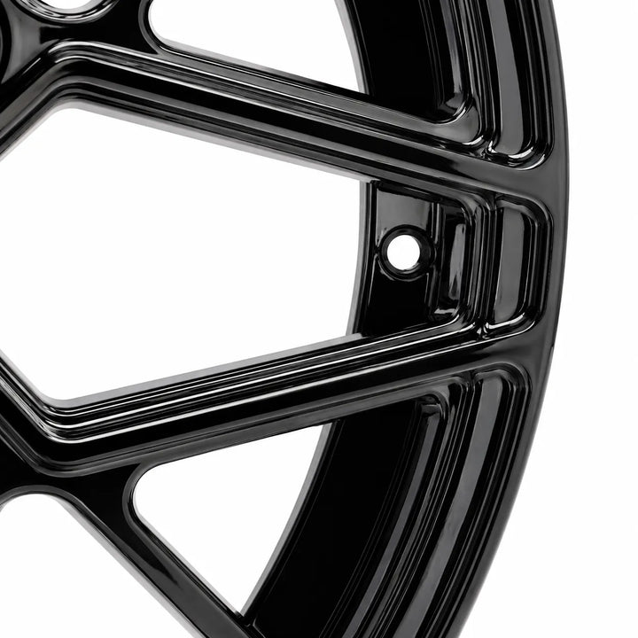 Close-up of a glossy black multi-spoke alloy wheel rim on a white background.