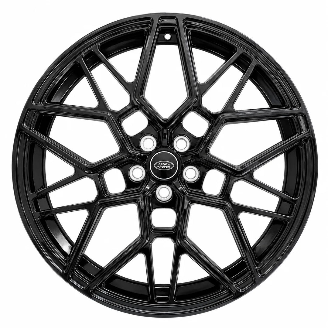 A black multi-spoke alloy wheel rim with a glossy finish and a central logo badge, shown against a plain white background.