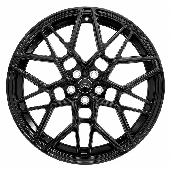 A black multi-spoke alloy wheel rim with a glossy finish and a central logo badge, shown against a plain white background.