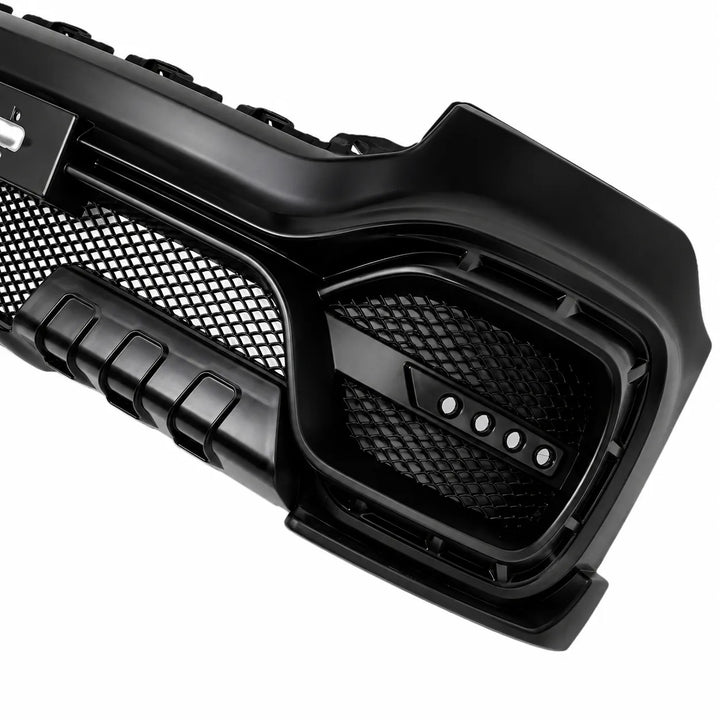 A close-up of a black automotive front grille with a mesh pattern and integrated speaker grilles, shown on a plain white background.
