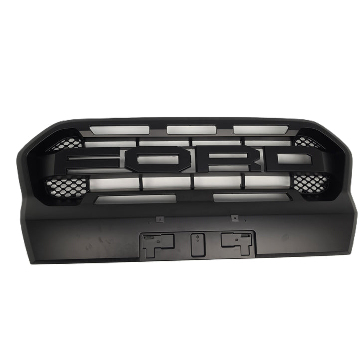 A black plastic Ford grille insert with a raised 'FORD' emblem and horizontal slats, shown against a plain white background.