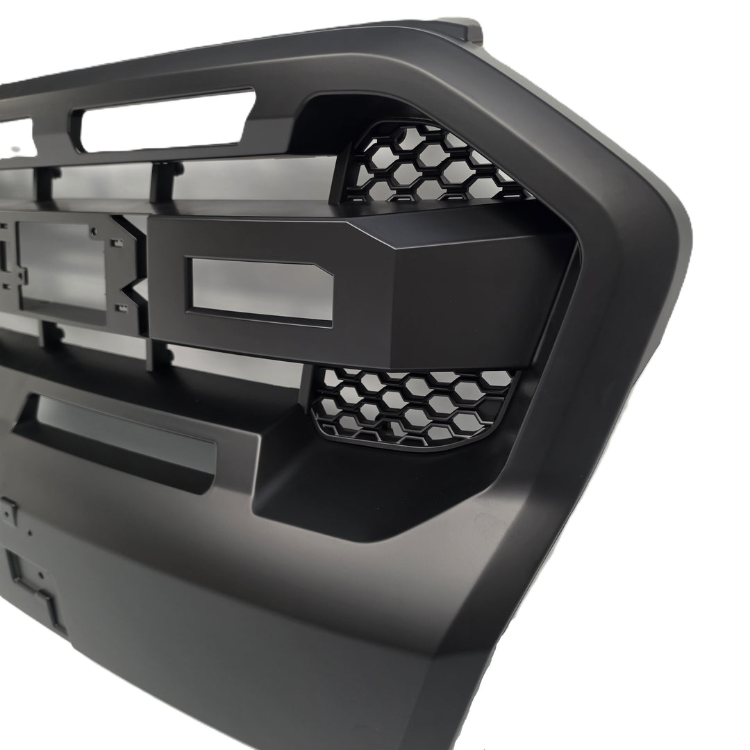 A close-up of a black heavy-duty truck grille or front bumper grille insert with honeycomb mesh details, shown on a white background.