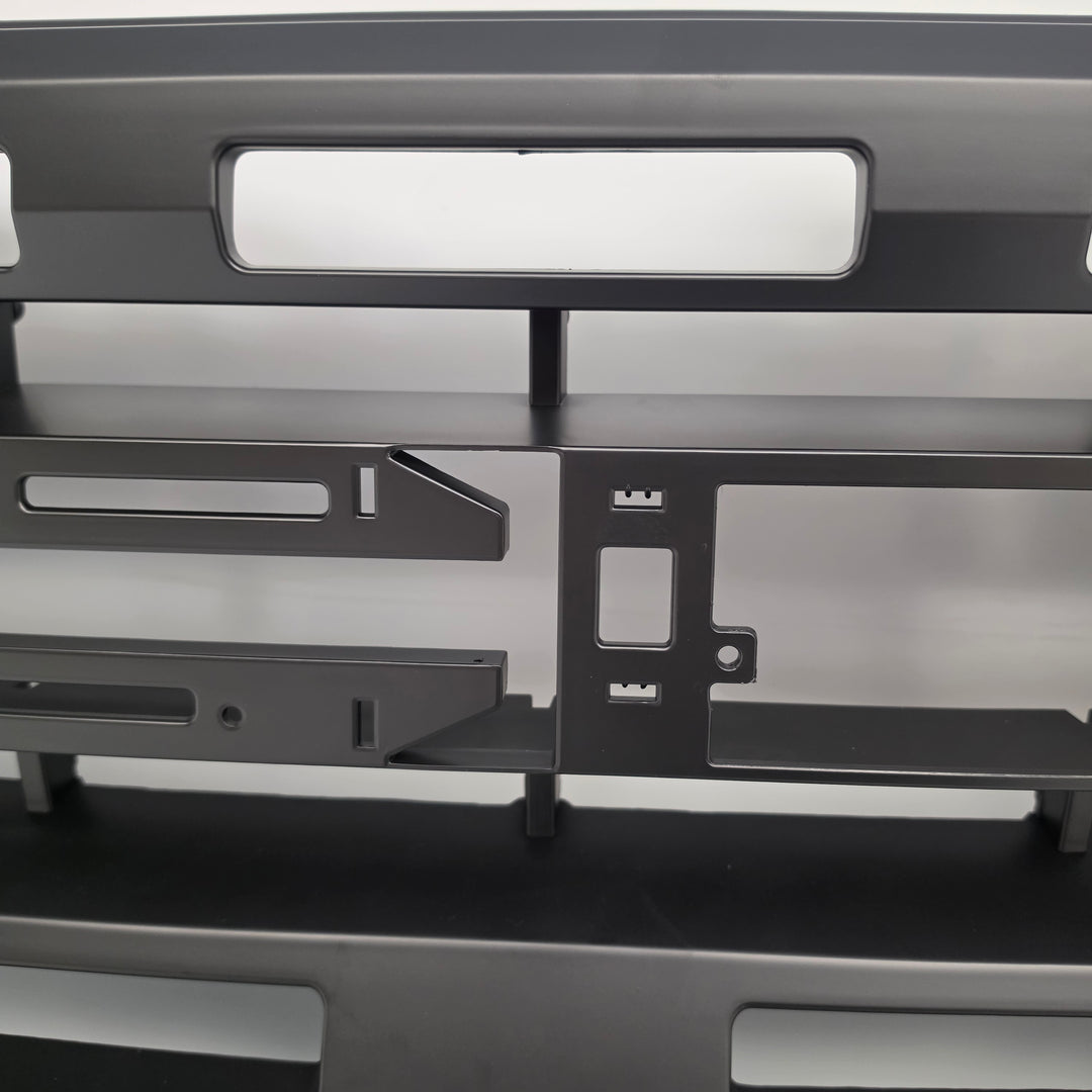 A close-up of a black heavy-duty grille or front bumper grille insert with honeycomb mesh details, shown on a white background.