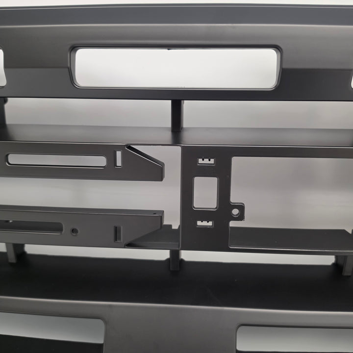 A close-up of a black heavy-duty grille or front bumper grille insert with honeycomb mesh details, shown on a white background.