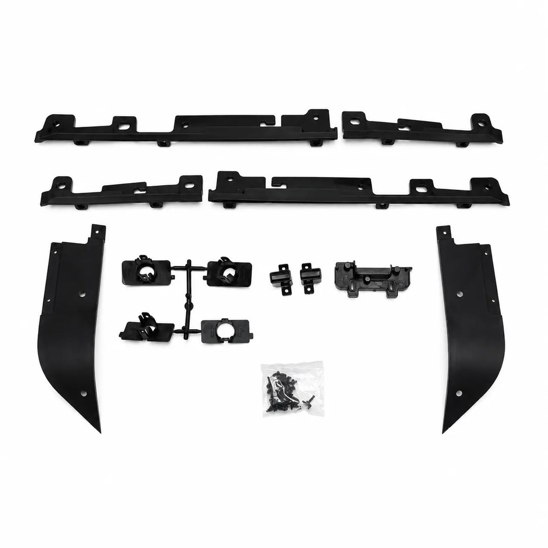 A set of black plastic automotive trim or body molding pieces laid out on a white background, including two long horizontal sections, two curved vertical sections, several smaller bracket pieces, and a small bag of hardware.