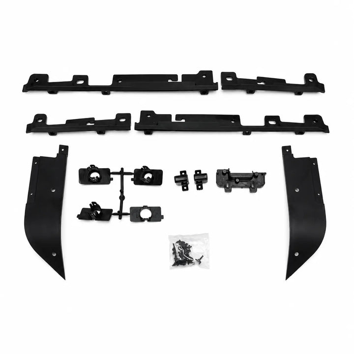 A set of black plastic automotive trim or body molding pieces laid out on a white background, including two long horizontal sections, two curved vertical sections, several smaller bracket pieces, and a small bag of hardware.