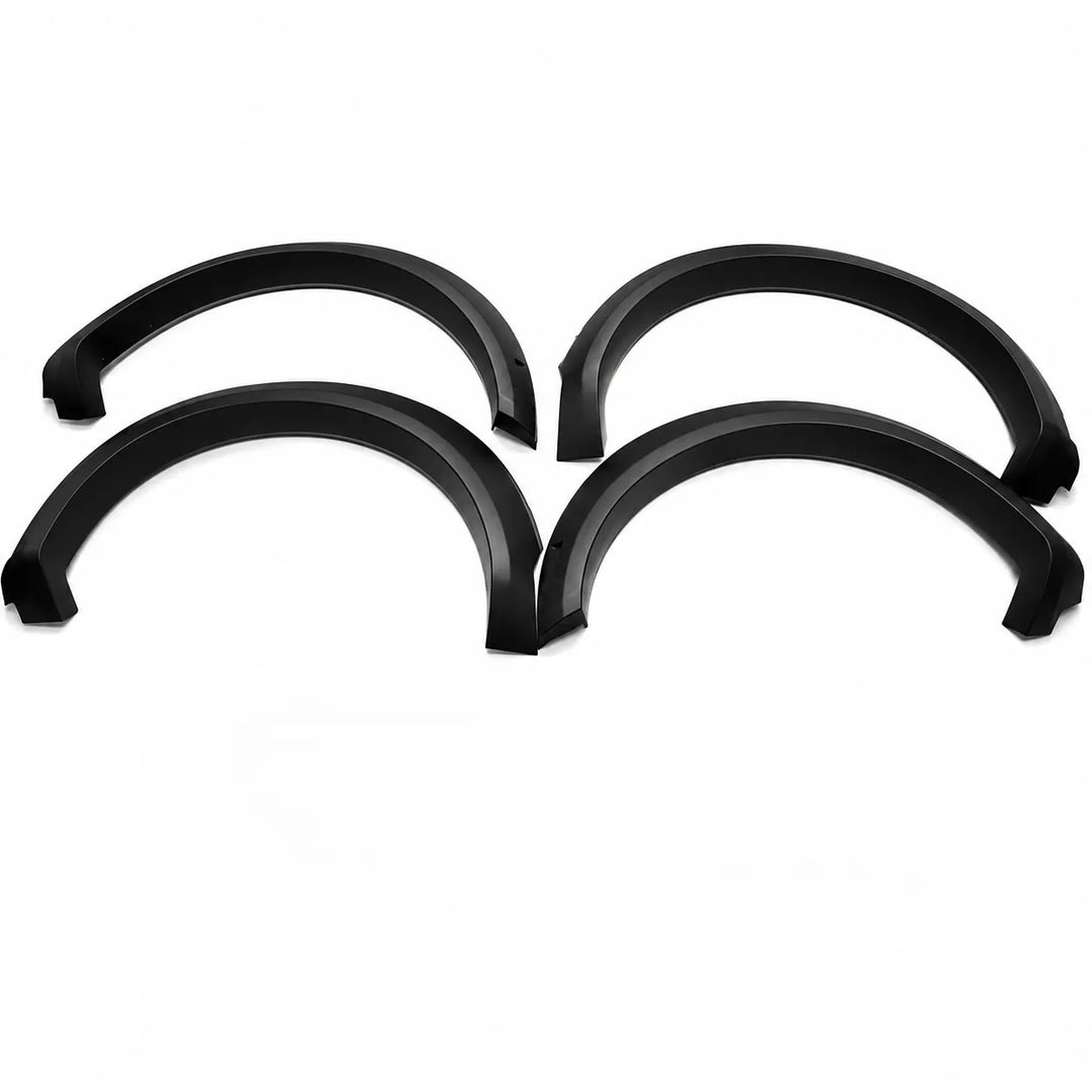 Four black plastic vehicle wheel arches or fender covers arranged in a 2x2 grid on a plain white background.
