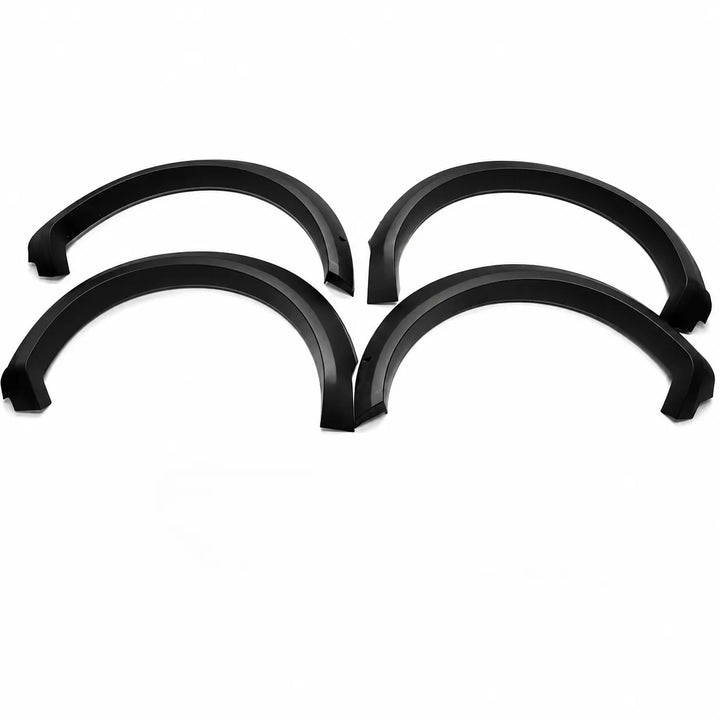 Four black plastic vehicle wheel arches or fender covers arranged in a 2x2 grid on a plain white background.