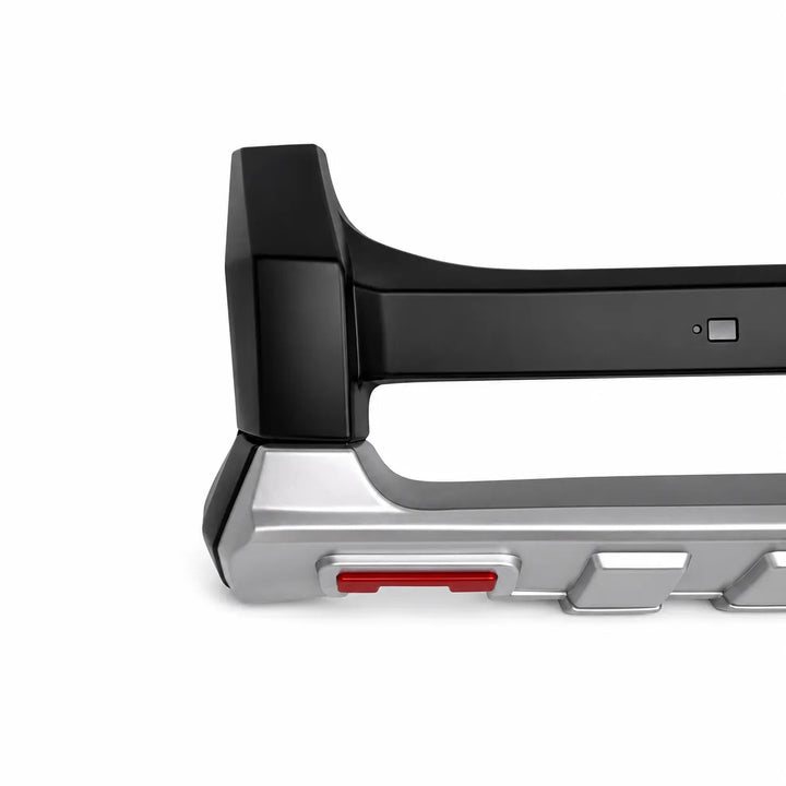 Close-up of a vehicle bumper bar or tow bar attachment with a black unpainted upper section and a silver lower section, featuring a small red accent, on a white background.
