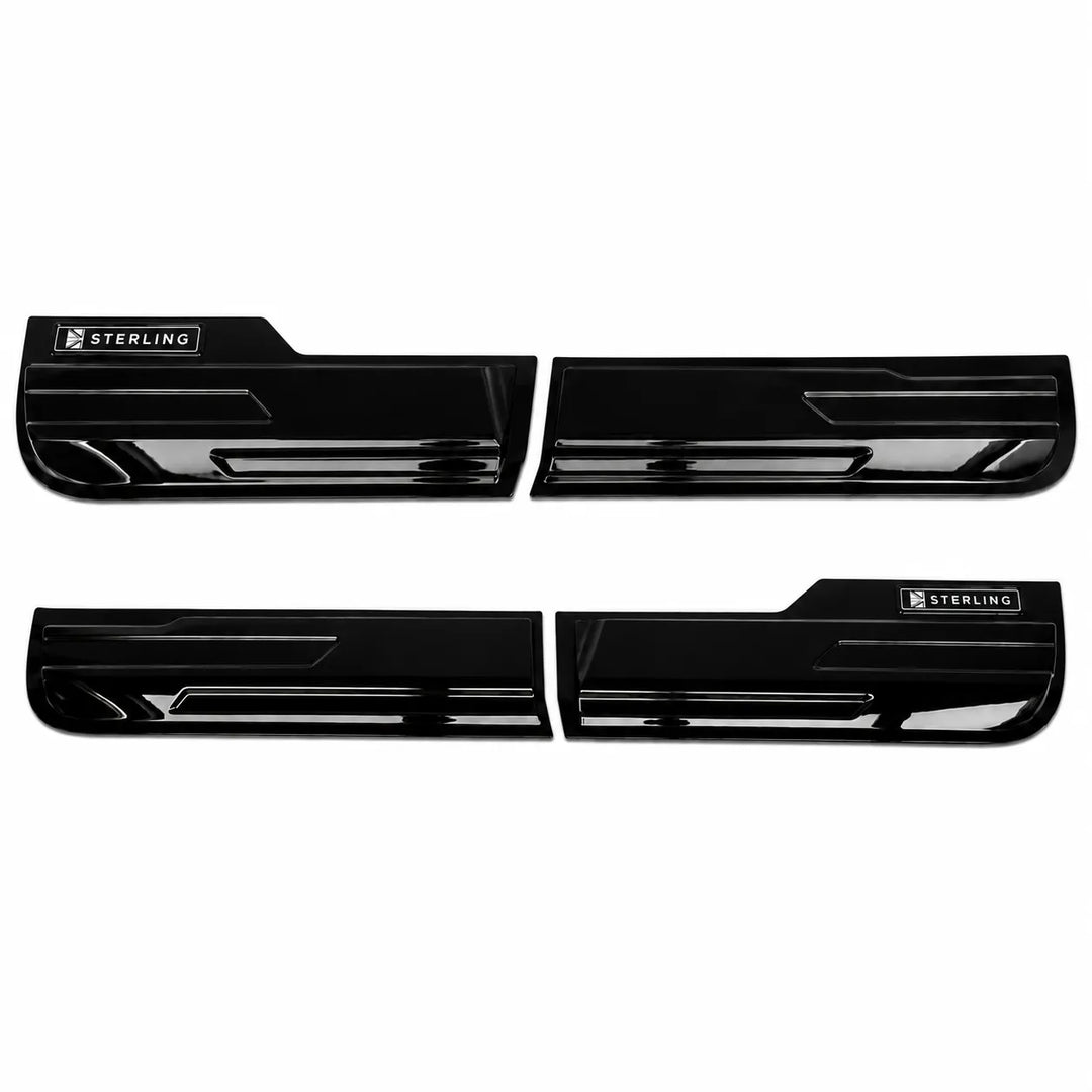 Four glossy black automotive door sill trim pieces arranged in two pairs on a plain white background, with a small Sterling brand badge visible on each piece.