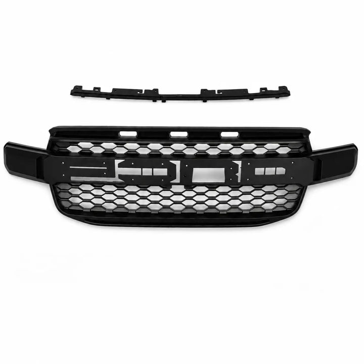 A black honeycomb grille and matching upper trim piece for a vehicle front bumper, displayed on a clean white background.