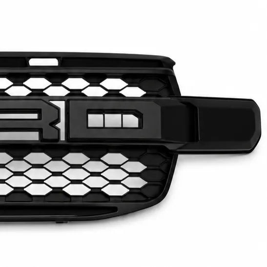 A close-up of a black vehicle grille with a honeycomb pattern and 'R' 'D' emblem, shown on a white background.