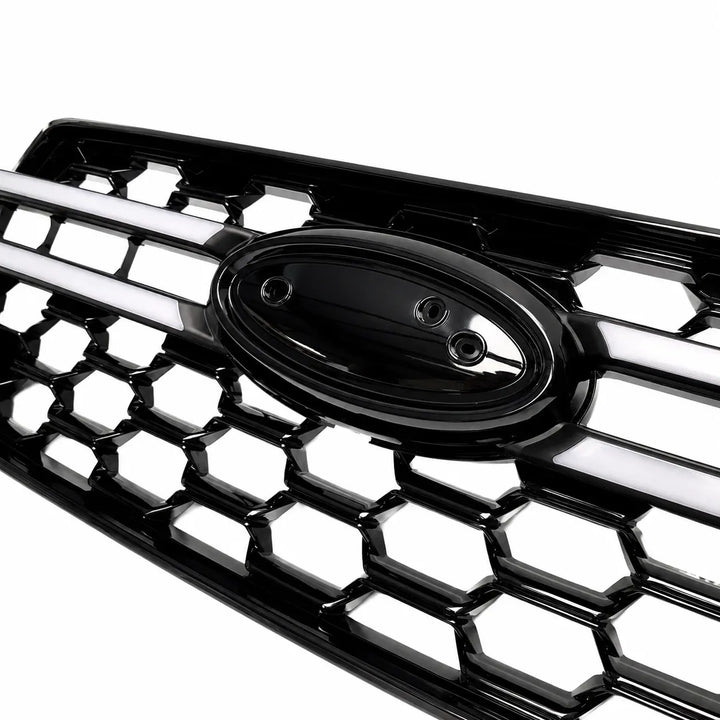 A close up shot of a glossy black honeycomb truck car grille with a central oval badge, shown on a clean white background.