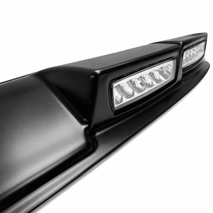 Close-up of a car's black roof light with integrated LED lights on a white background

