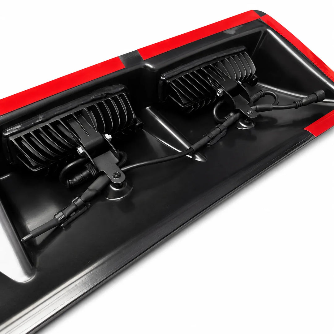 Close-up of a underneath truck roof light with 3m red tape trim.