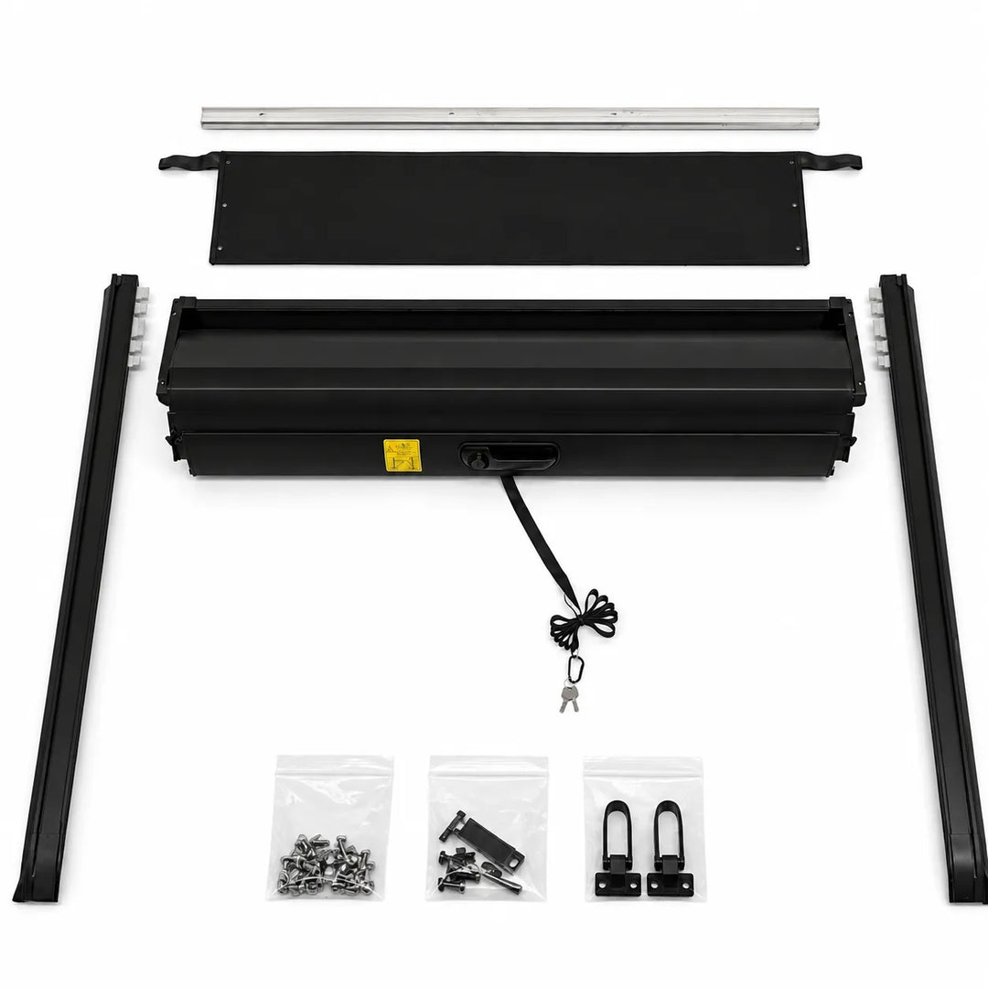 A black metal roller shutter kit laid out on a white background, including two long rails, a long horizontal bar, a rectangular panel, a long narrow bar, small hardware bags, and a hanging cable with keys.