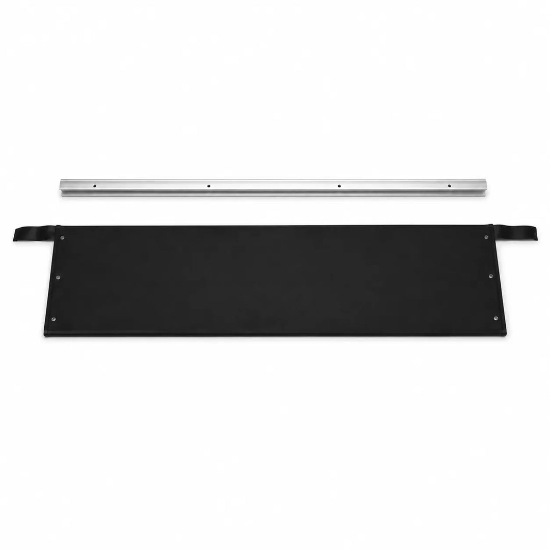A black rectangular panel with metal grommets and a strap on one side, shown below a long silver metal rail on a plain white background.